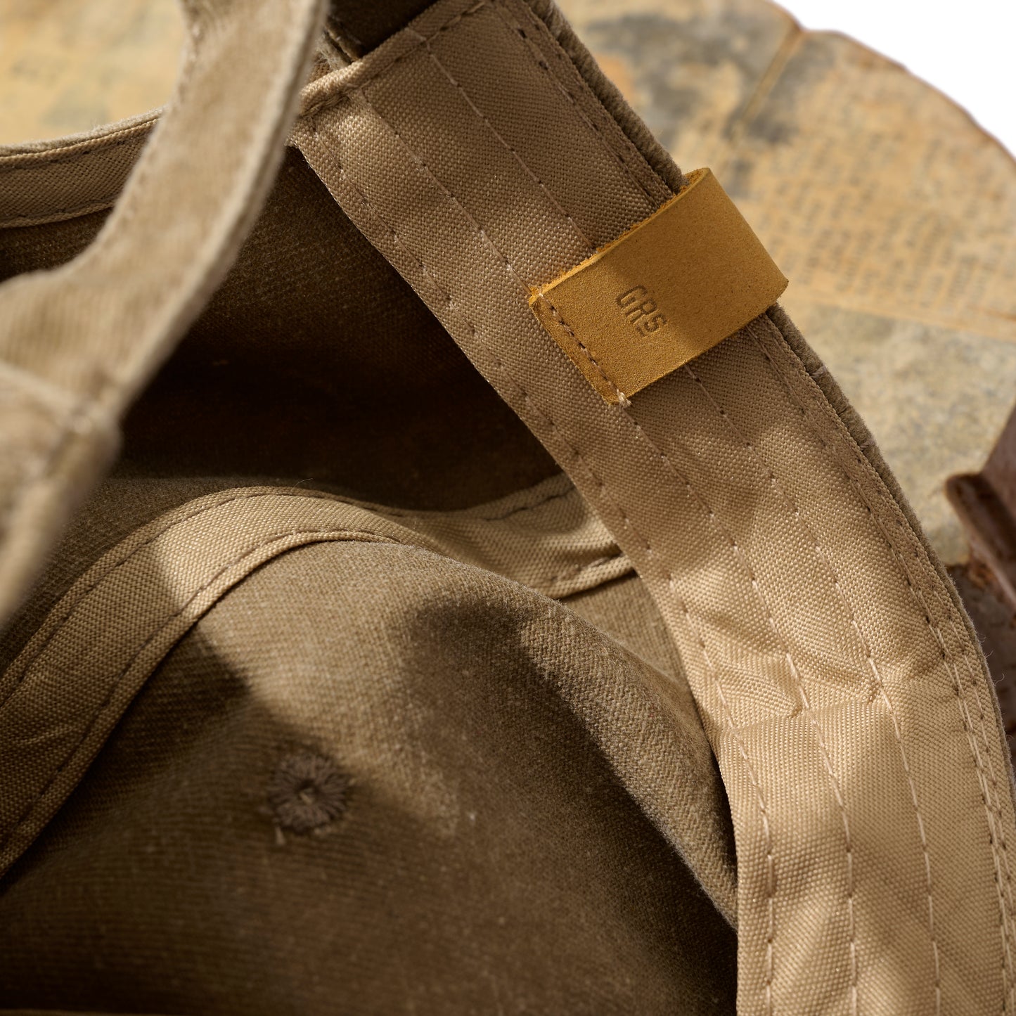 FADED WASHED HAND QUILTED “KOWLOON” CAP / DESERT TAN