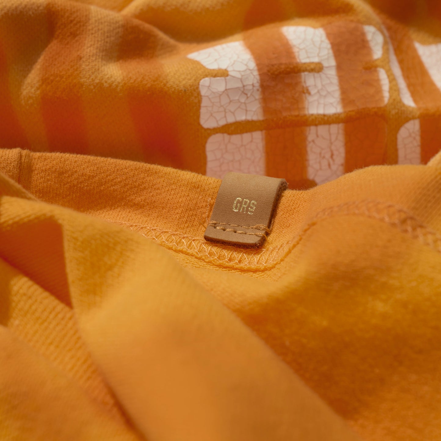 SUN FADED HAND STENCIL WASHED “KOWLOON” TEE / SIGNAL ORANGE