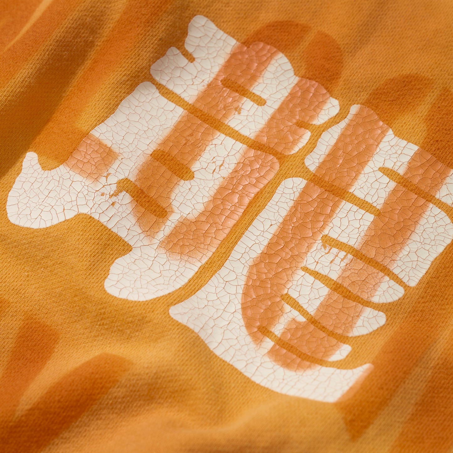 SUN FADED HAND STENCIL WASHED “KOWLOON” TEE / SIGNAL ORANGE