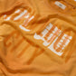 SUN FADED HAND STENCIL WASHED “KOWLOON” TEE / SIGNAL ORANGE