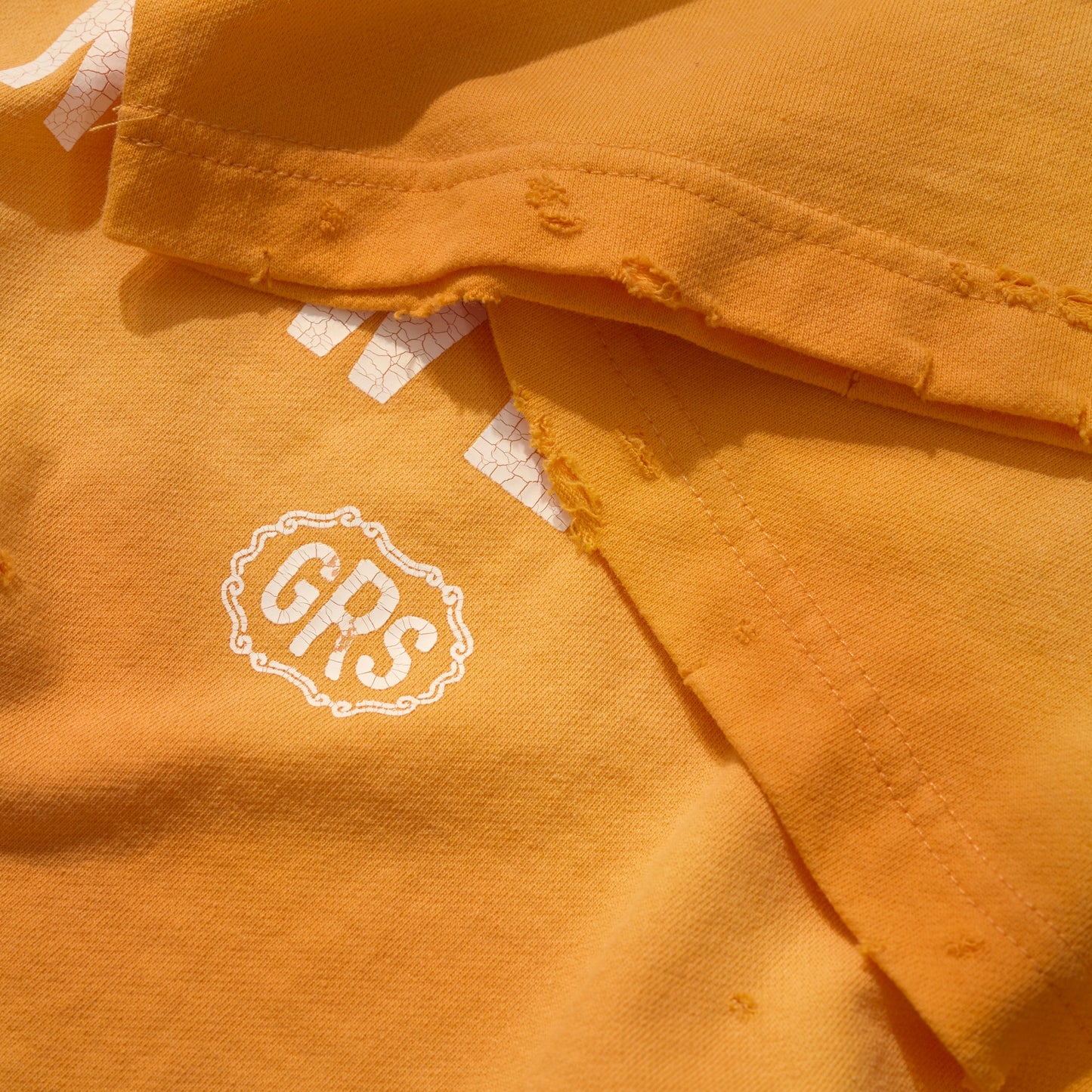 SUN FADED HAND STENCIL WASHED “KOWLOON” TEE / SIGNAL ORANGE