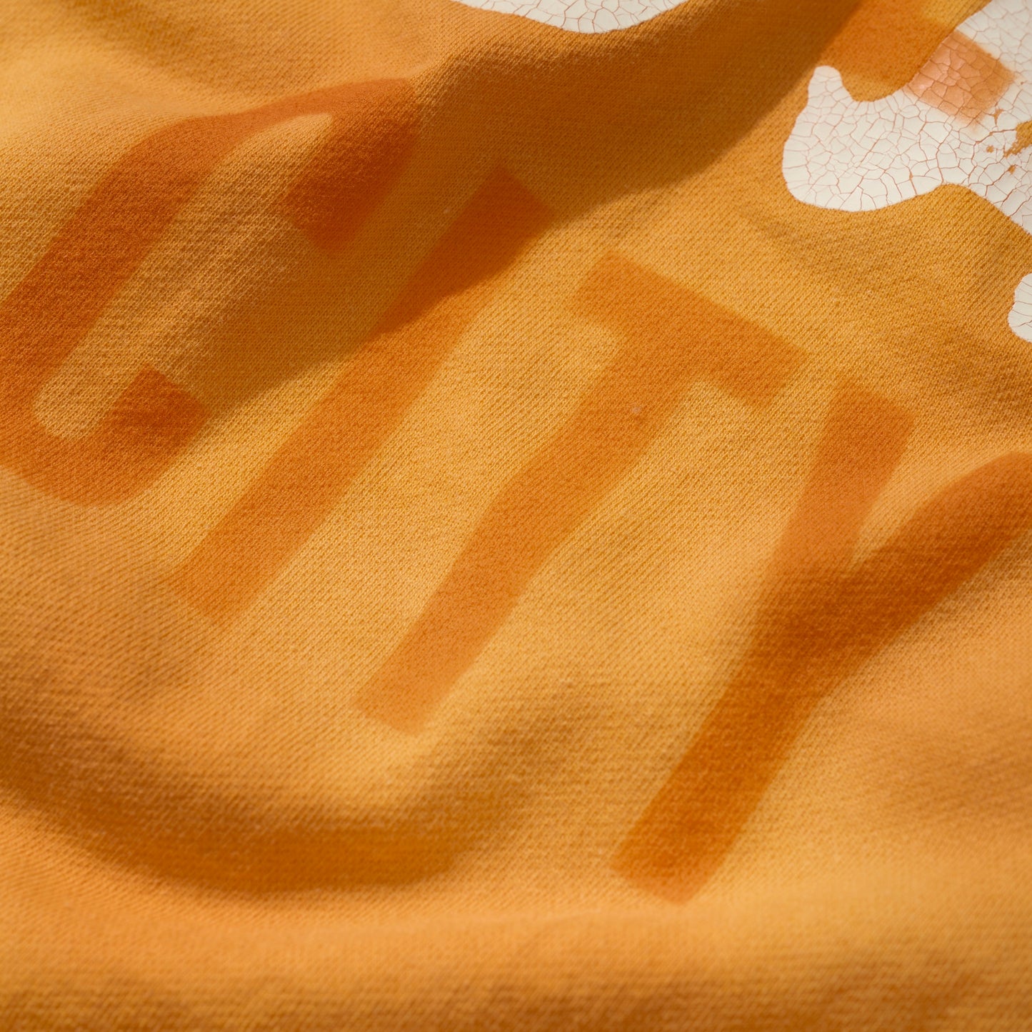 SUN FADED HAND STENCIL WASHED “KOWLOON” TEE / SIGNAL ORANGE